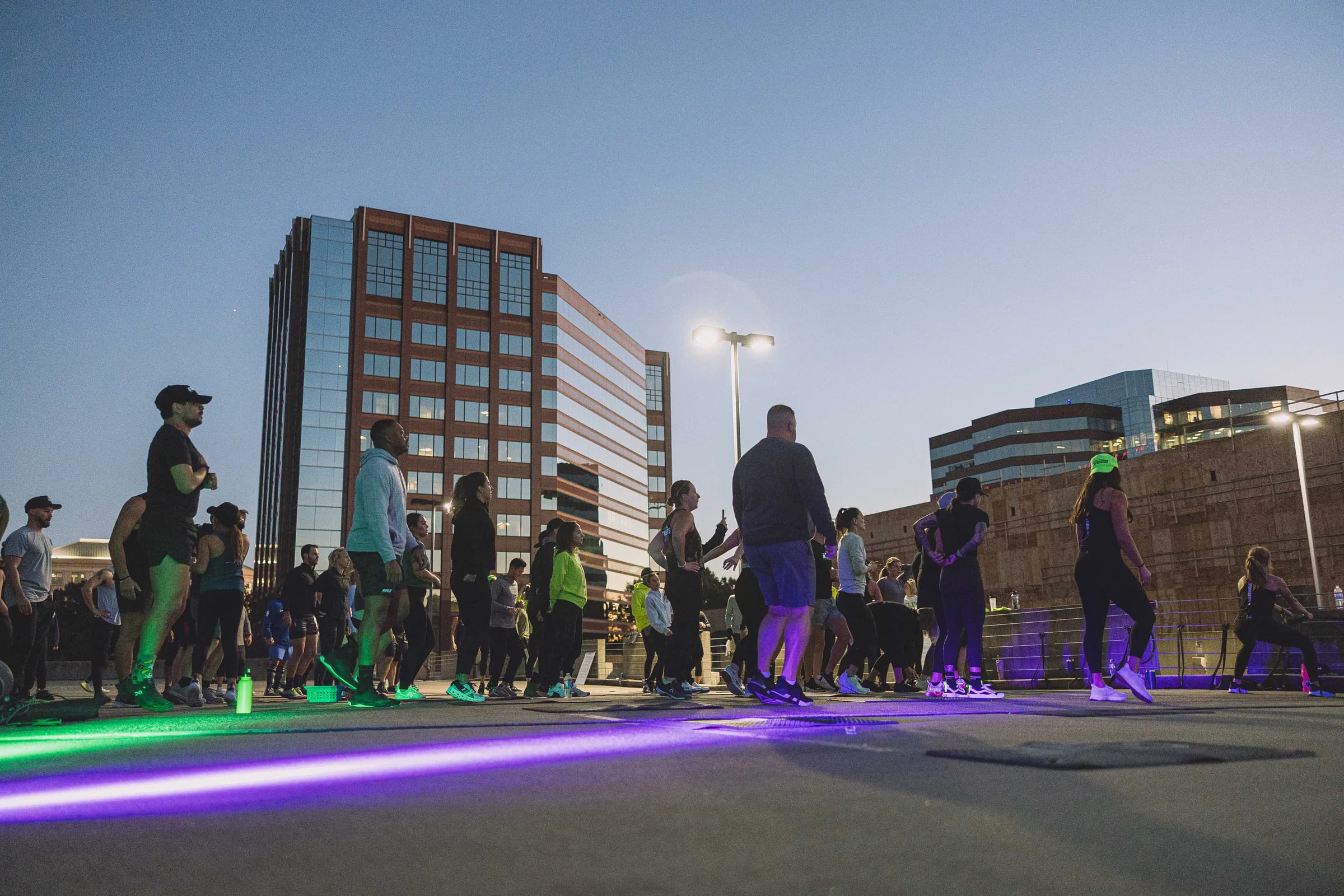 Convention attendees working out outdoors at dusk