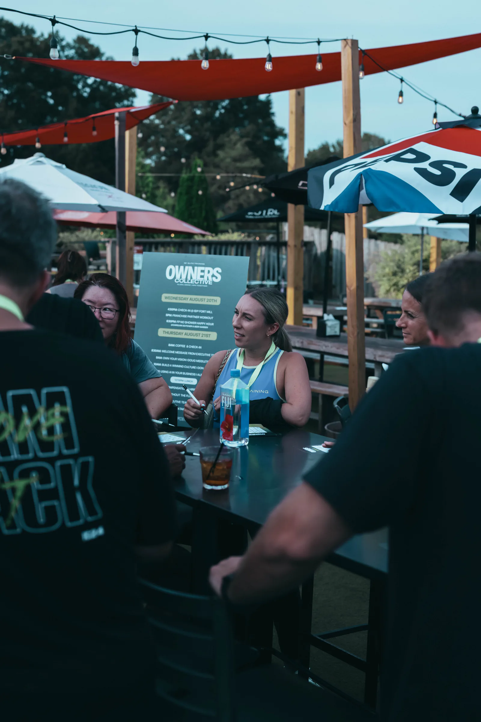 Attendees connecting at an outdoor Owners Collective event