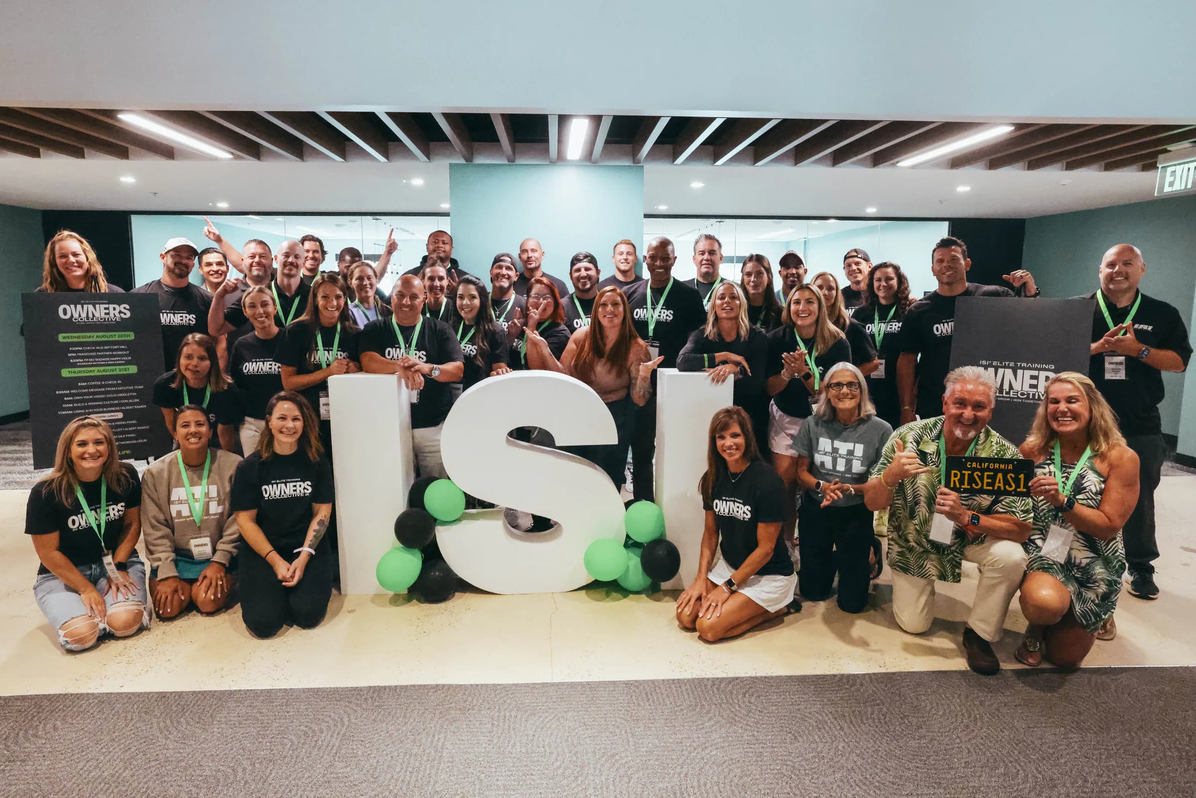 Owners Collective attendees gathered around the ISI logo