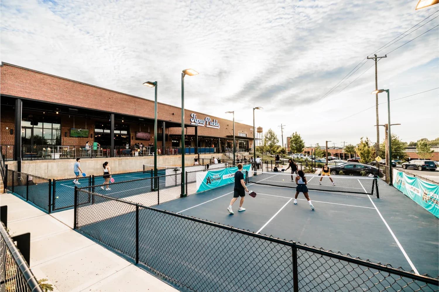 Players on the outdoor pickleball courts at Tipsy Pickle in Charlotte
